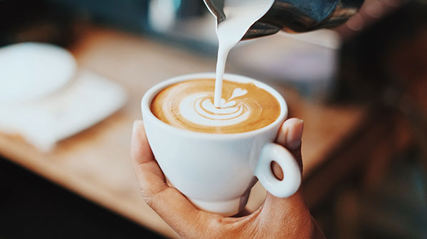 Image of milk being poured into a coffee cup